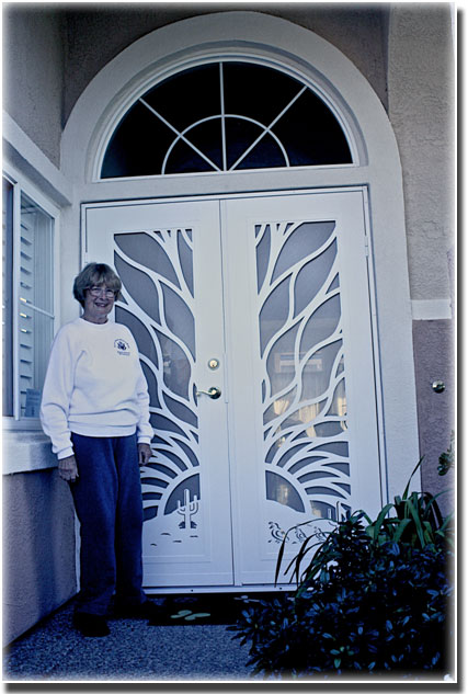 woman in white shirt standing in front of two white designer double doors