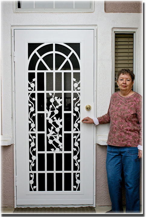 woman standing in front of white security screen door