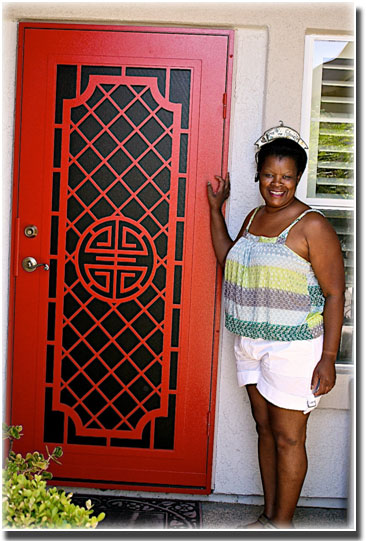 woman standing in front of red screen door