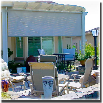 Roll Down Window Sun Screen lowered slightly over windows lounge chairs  and plants sen in patio