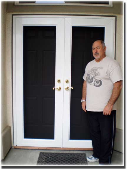 two white double doors and a man standing in front