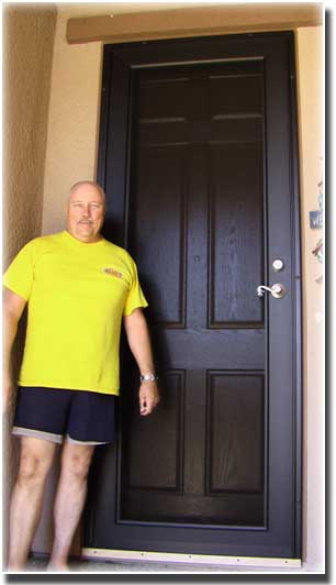 man in yellow shirts and shorts standing by brown wooden front door