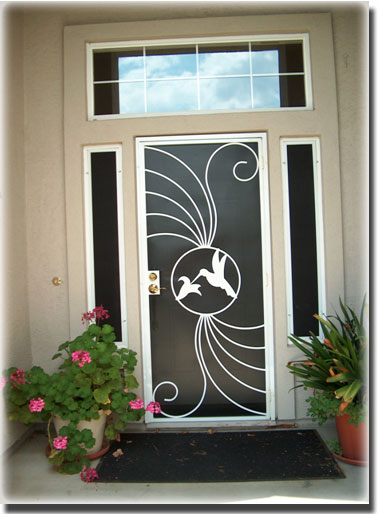 Brown Front Door Solar Screen with hummingbird pattern and flowers in pot in front