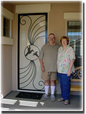 older man and woman standing by designer screen door