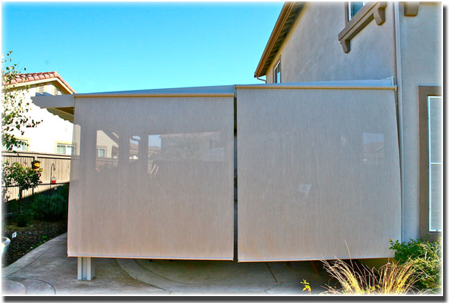 Stucco Roll Down Screens lowered over patio with fence on the left