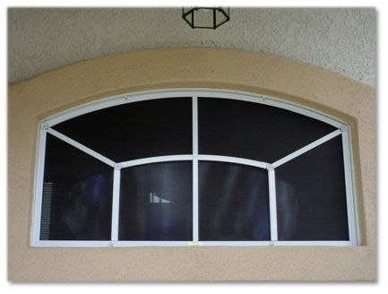 sunscreen installed on rectangular shaped window with arch on top