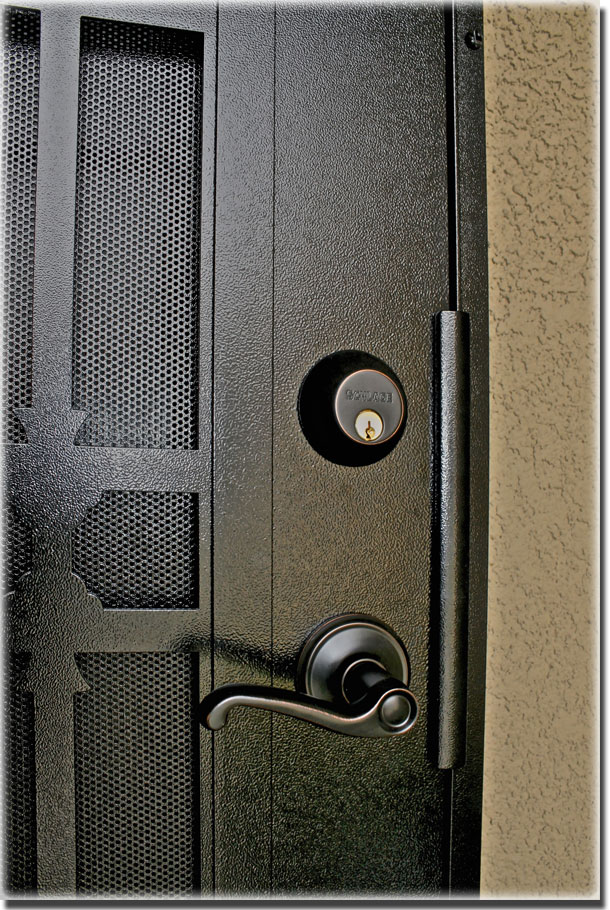 Black security door shown close up with door handle and lock