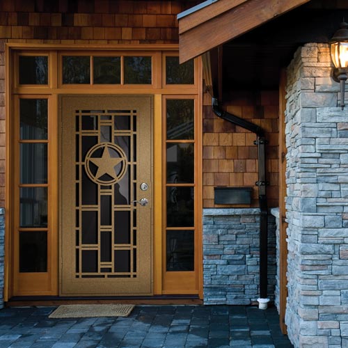 brown security screen door on home with circle pattern with star inside and borders of the door are small windows
