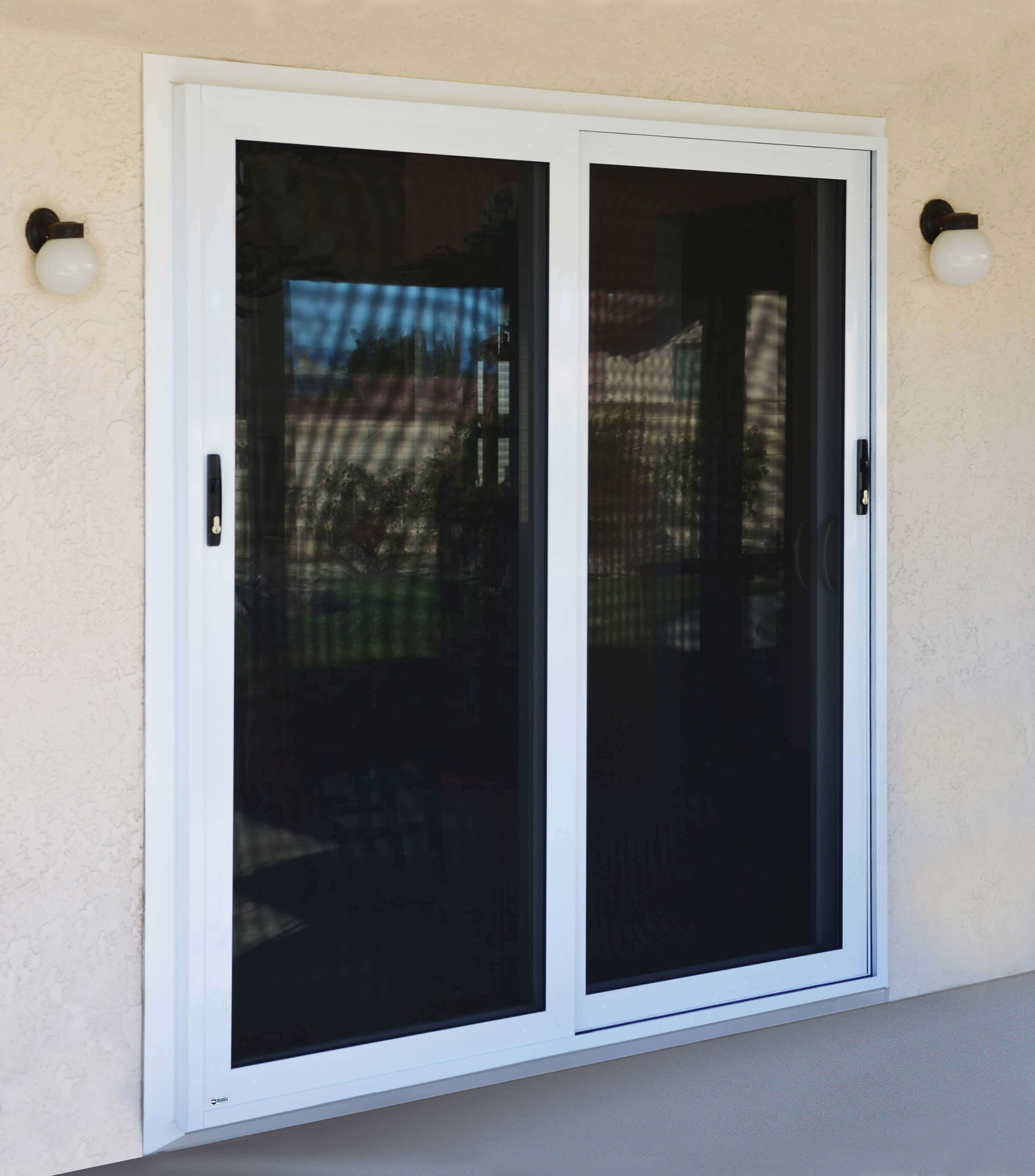 Sliding security screen doors with white trim on home