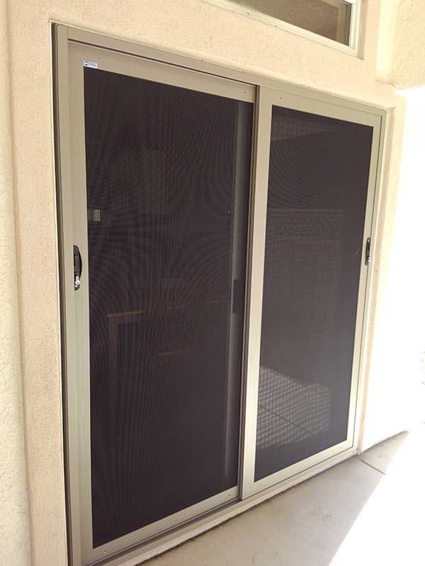 Two black sliding secuirty doors with white around the  the trim
