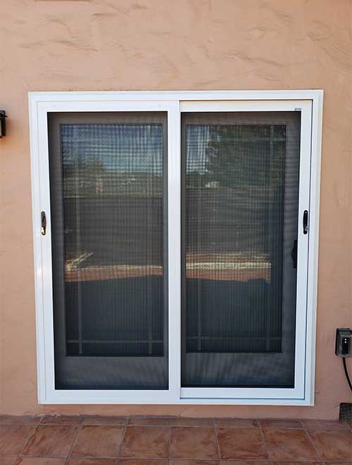 Two glass sliding doors with white trim
