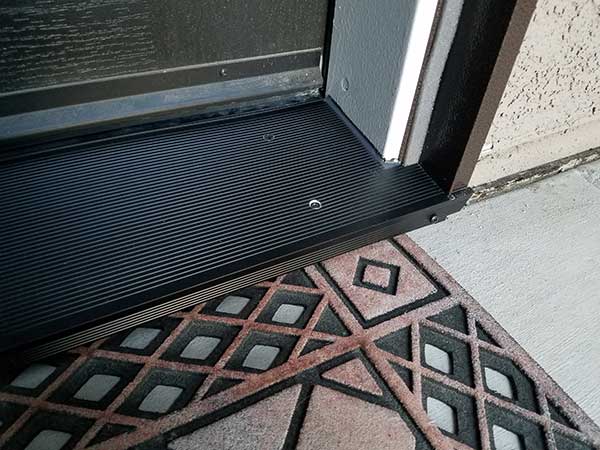 bottom right of doorway with a door mat in front of it it
