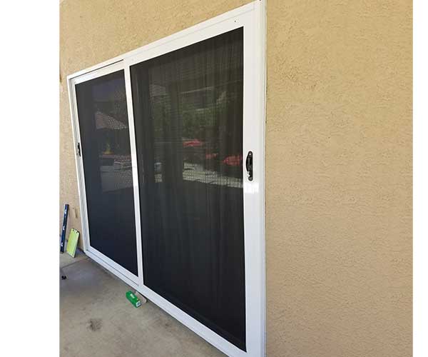 Two black sliding security doors with white trim